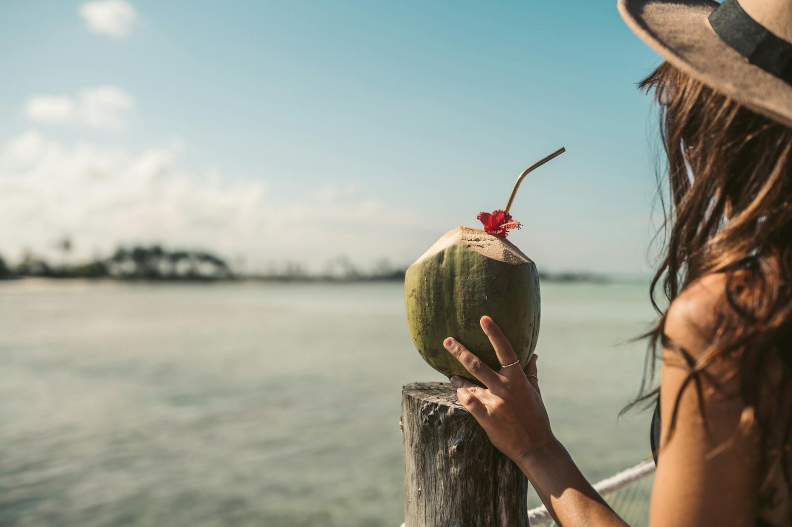 person holding a coconut drink 1